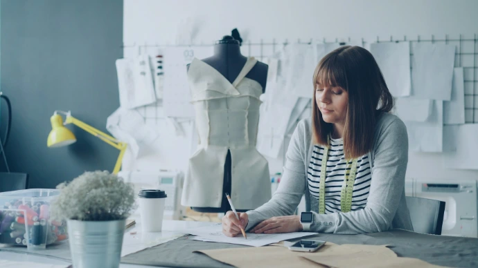 A fashion designer sketching in her atelier